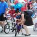 A little one gets a helping hand while participating in the 23rd Annual Ann Arbor Jaycees Fourth of July Parade on Thursday, July 4, 2013 in downtown Ann Arbor. Melanie Maxwell | AnnArbor.com